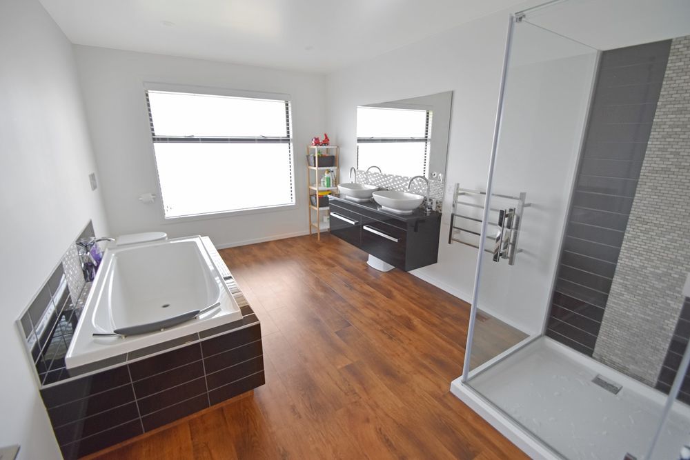 Finished main bathroom with bath, double vanity and tiled shower