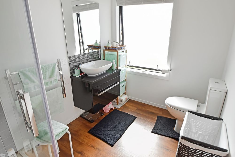 Finished bathroom with vessel basin vanity and toilet