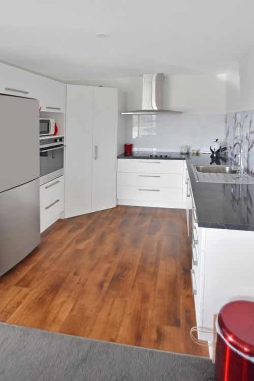 Finished white kitchen with black benchtop