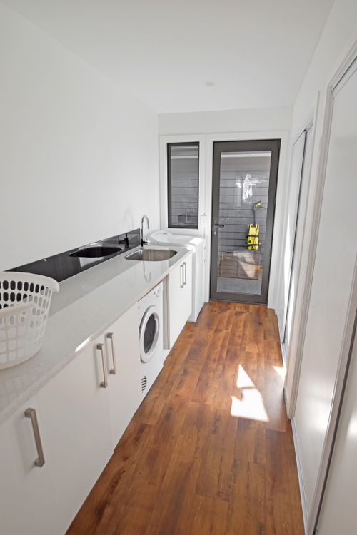 Finished laundry with double tub and washing machine plumbed in